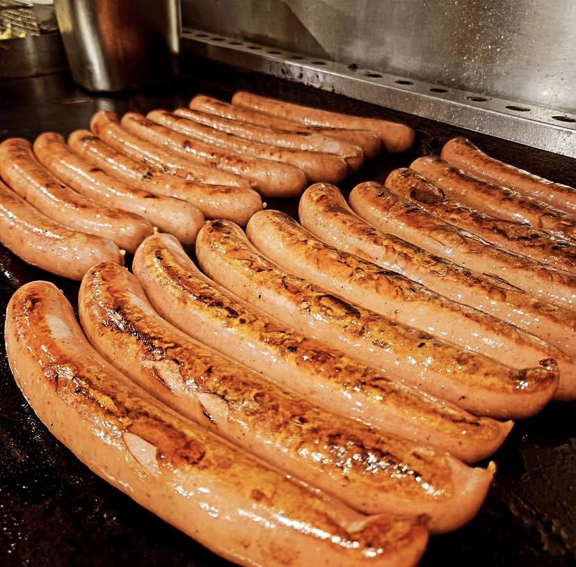 Rows of bratwurst on the grill