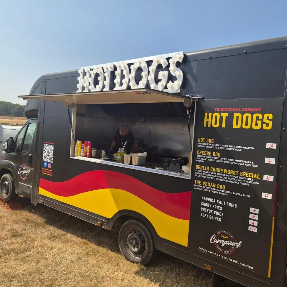 The Currywurst flagship food truck in black with German flag stripes
